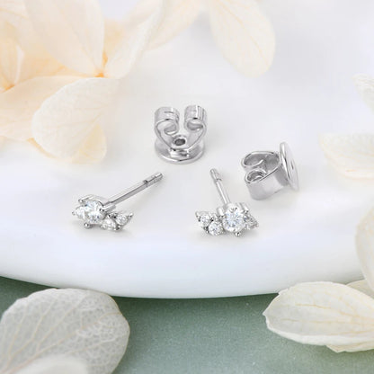 moissanite stud earrings for women displayed on a decorative surface with soft petals.